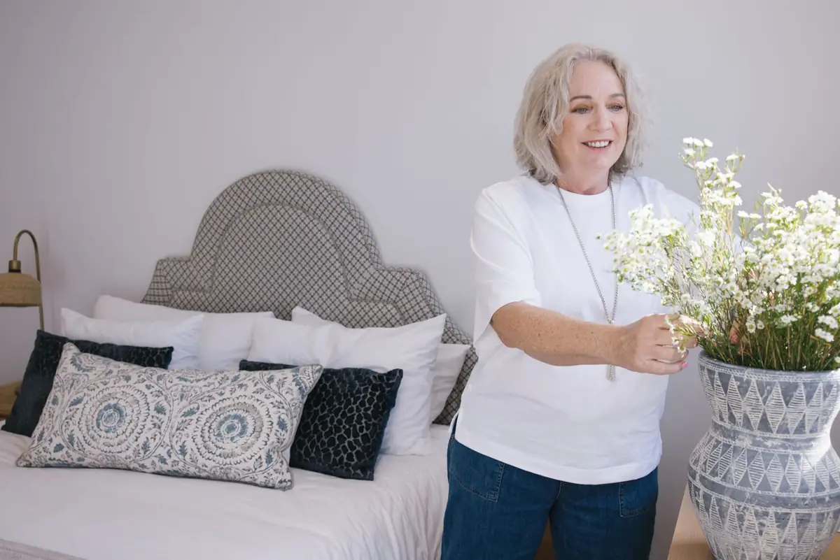 A resident arranging flowers at home