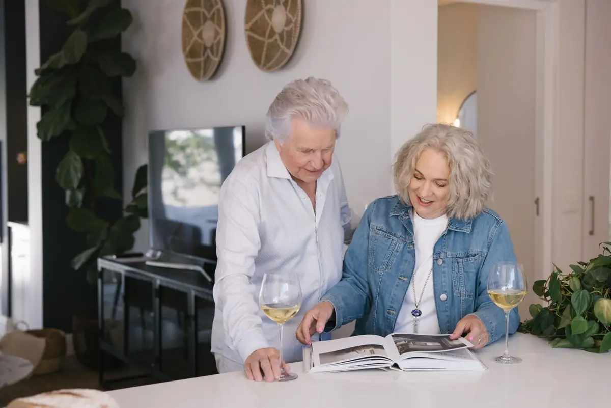 Two residents sharing a glass of wine at home